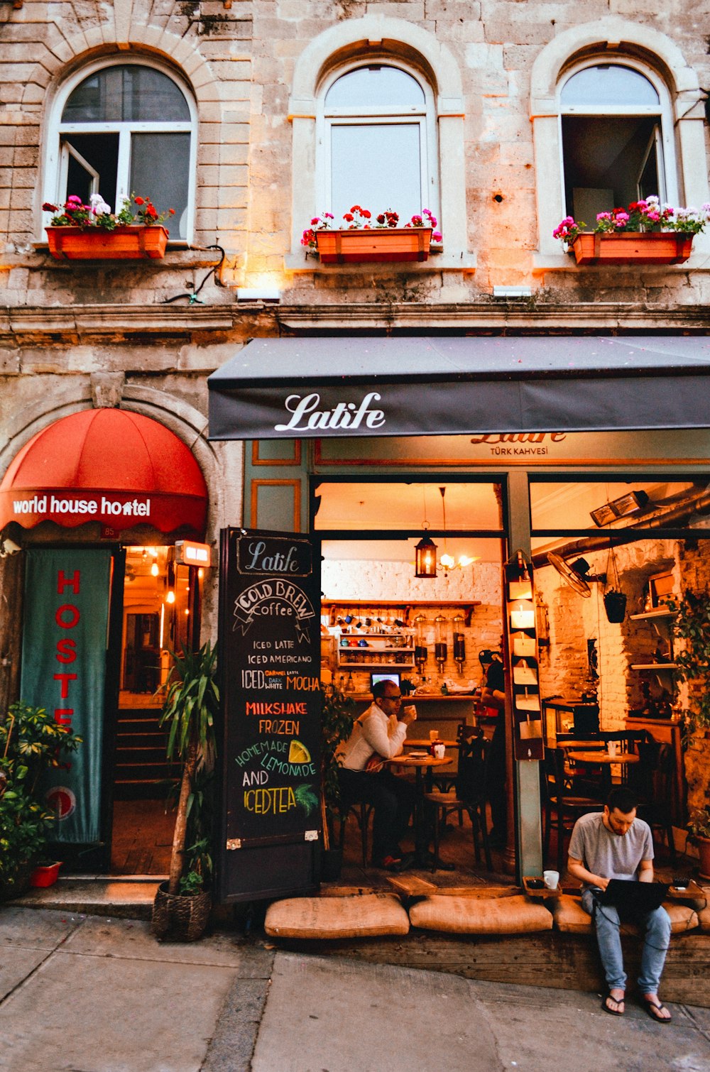 a couple of people sitting outside a restaurant