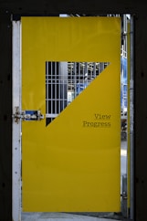 a yellow door with a metal gate