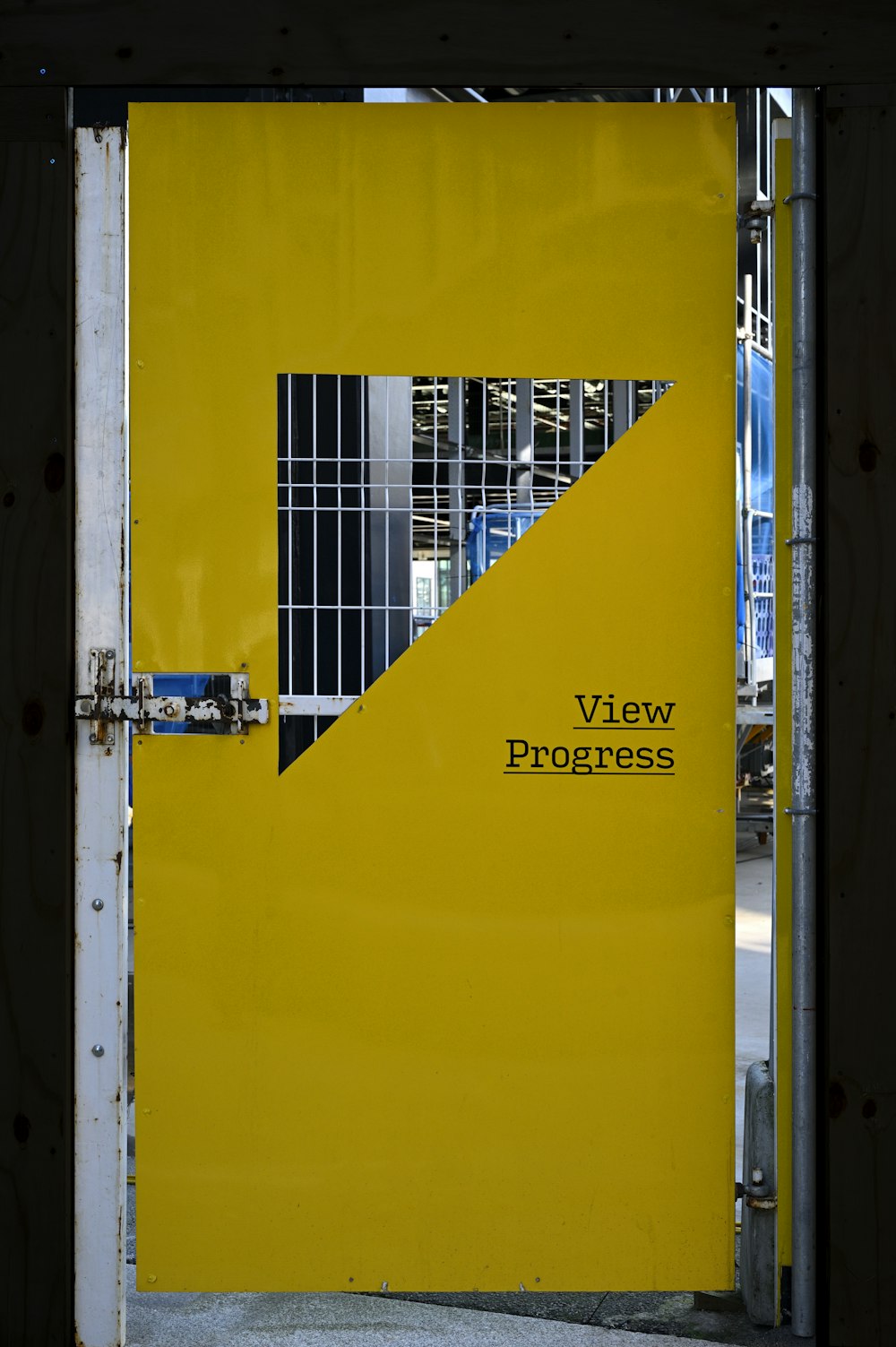 a yellow door with a metal gate