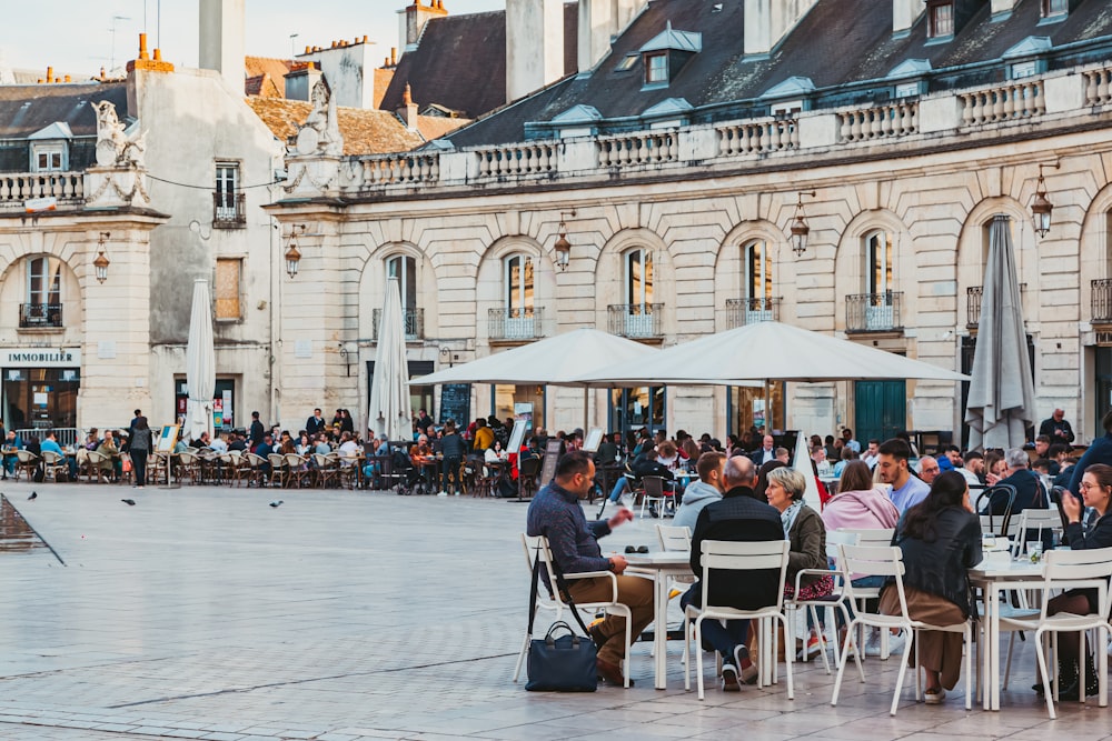 people sitting at tables outside