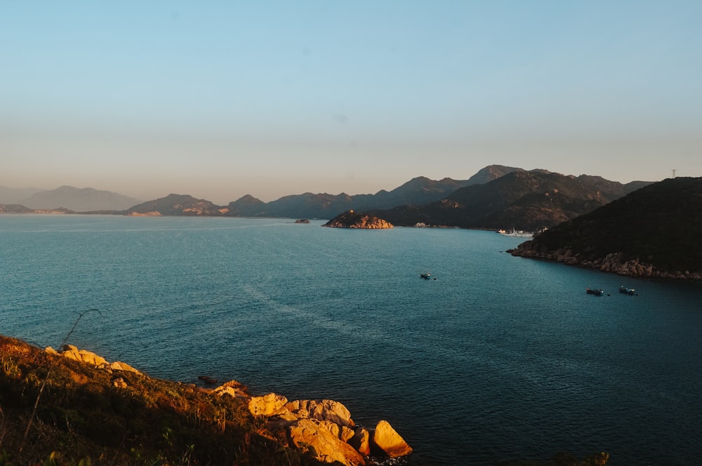 a body of water with hills in the background