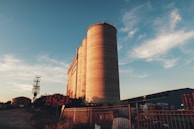 Technicians inspecting a newly installed silo's structural details at sunset.
