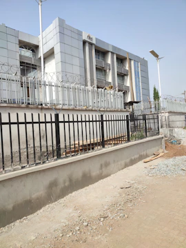 A government facility exterior with subtle security features and neutral tones.