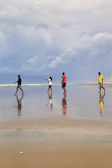 a group of people playing on the beach