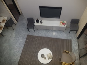 A flat-screen TV mounted on the wall of the hotel room.