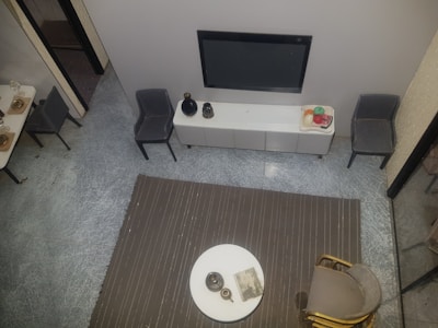 A sleek flat-screen television mounted on a wall above a wooden console.