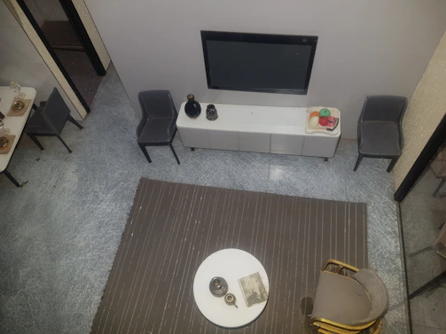 A modern apartment bedroom showcasing a TV mounted above a stylish wooden console.