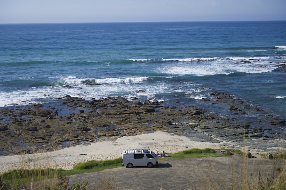 a white van parked on a beach