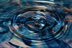 a close up of water ripples with a quote by Paulo Coelho