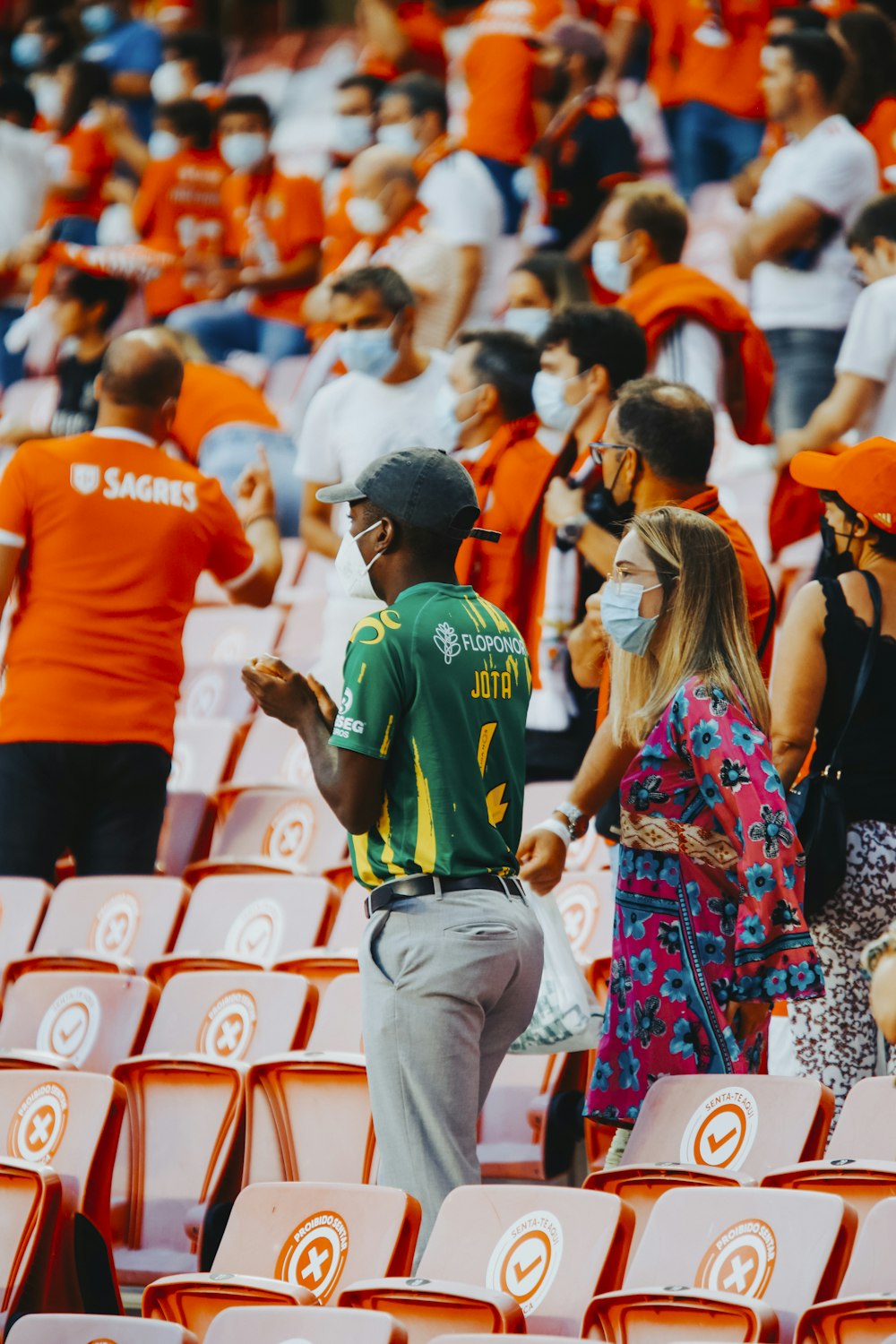 a man and woman talking to a crowd of people