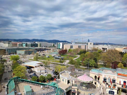 A panoramic 3D view of an urban development project showcasing buildings and parks.