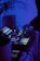 A DJ setup with turntables, mixers, and glowing LED lights in a dimly lit environment. A person is operating the equipment, adjusting the controls. The overall ambiance is cool with blue lighting, adding to a modern and energetic atmosphere.