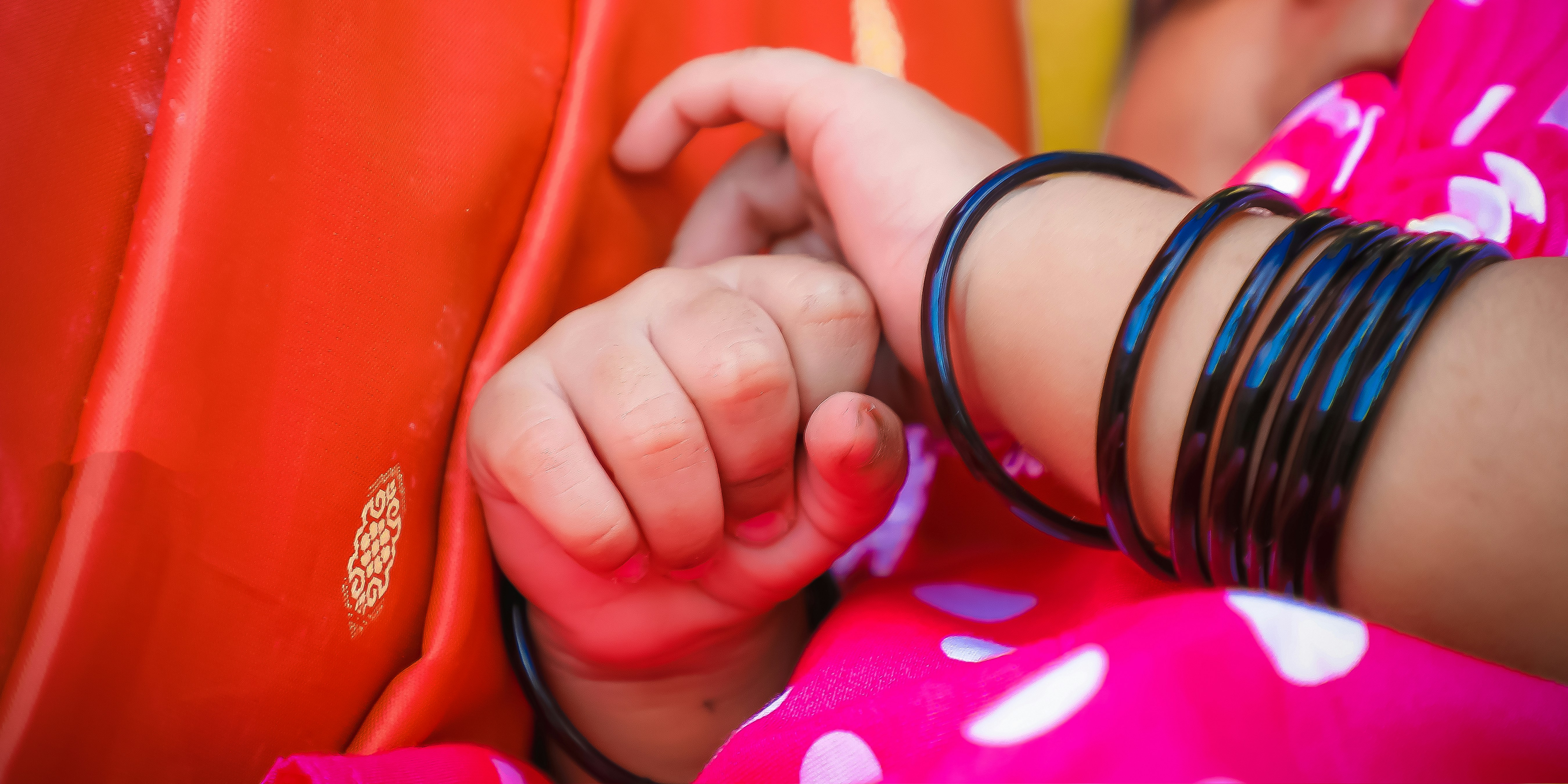 a child's hand holding a shoe