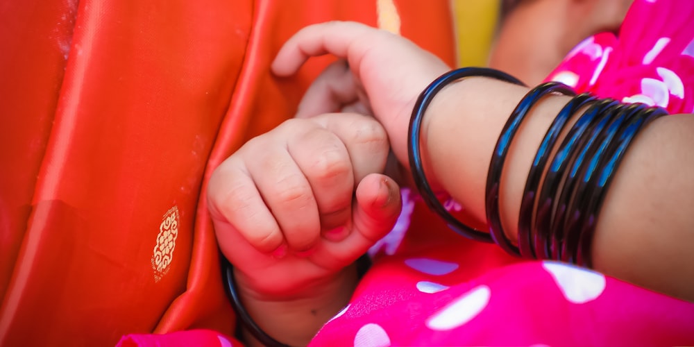 a child's hand holding a shoe