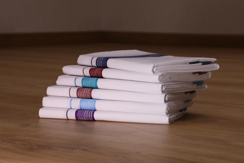 A neatly folded handkerchief showcasing intricate embroidered designs in vibrant colors.