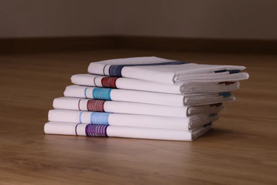 Close-up of soft facial tissues neatly stacked on a wooden table
