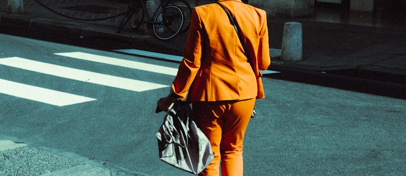 Trendsetter in orange walking the crosswalk
