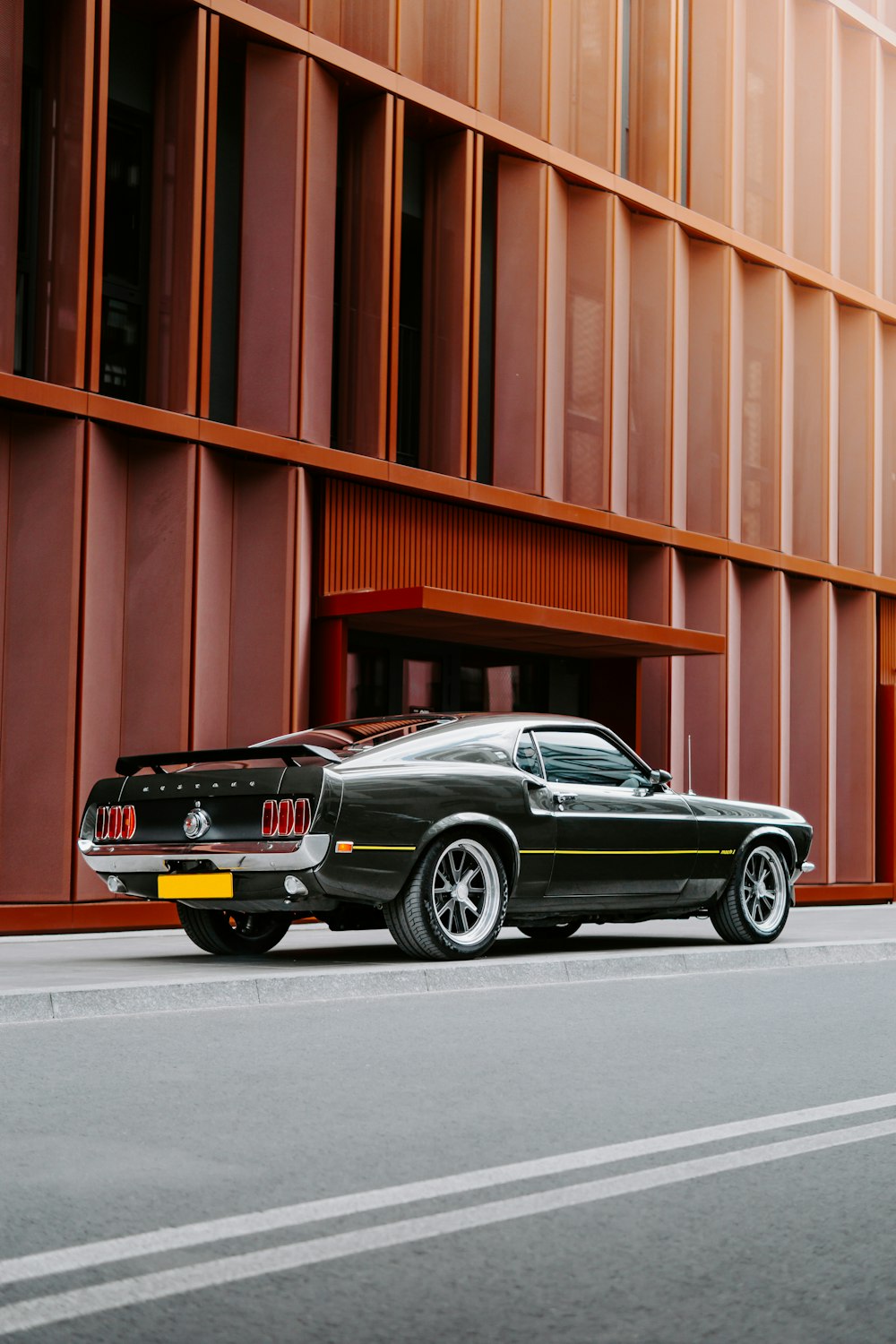 a black sports car parked in front of a building