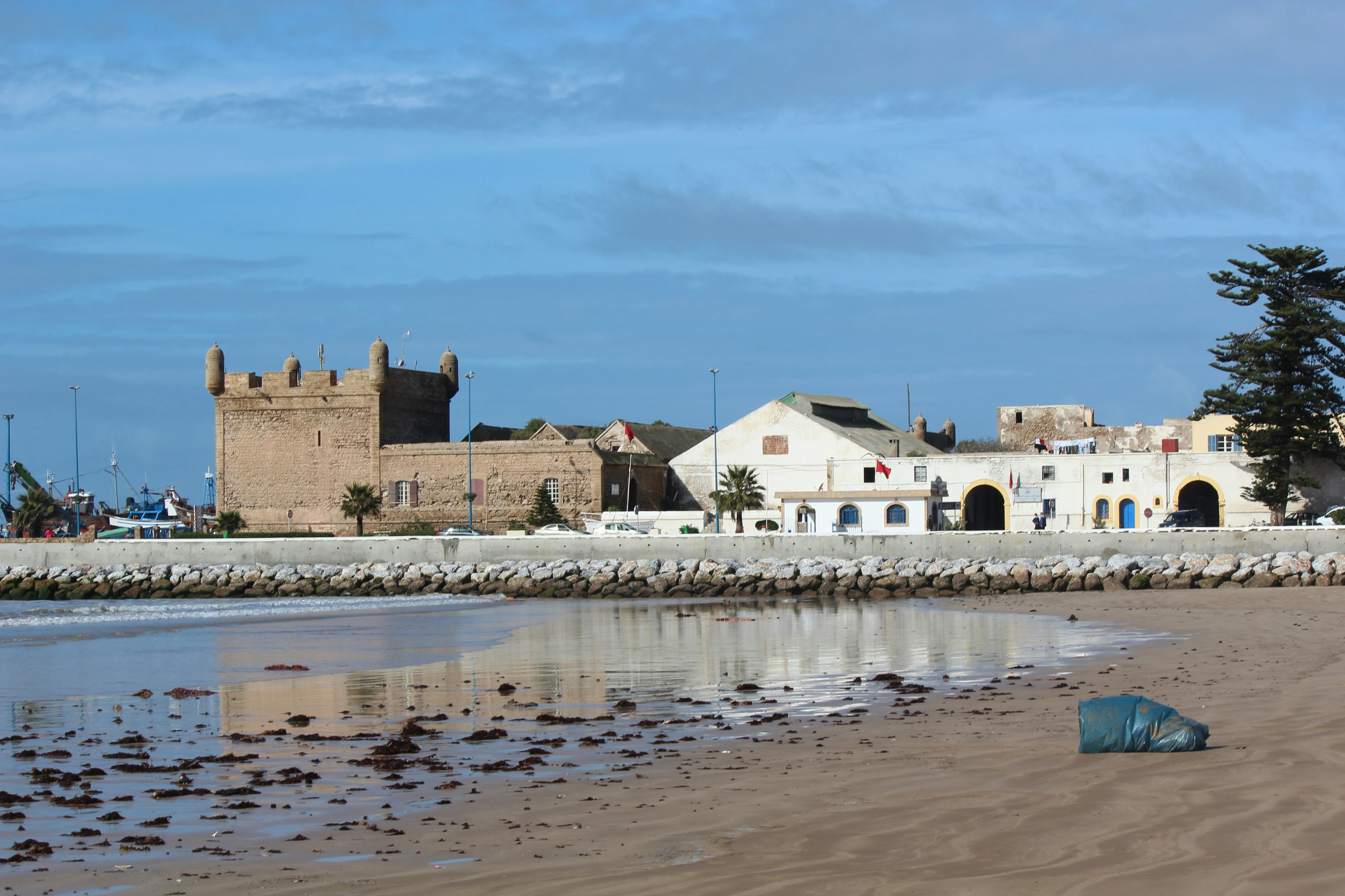 a stone wall with a stone wall and a building with a stone wall