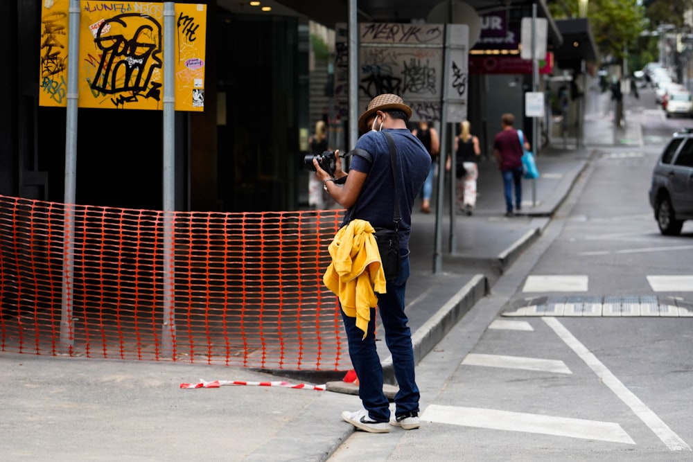 a person taking a picture of a street corner
