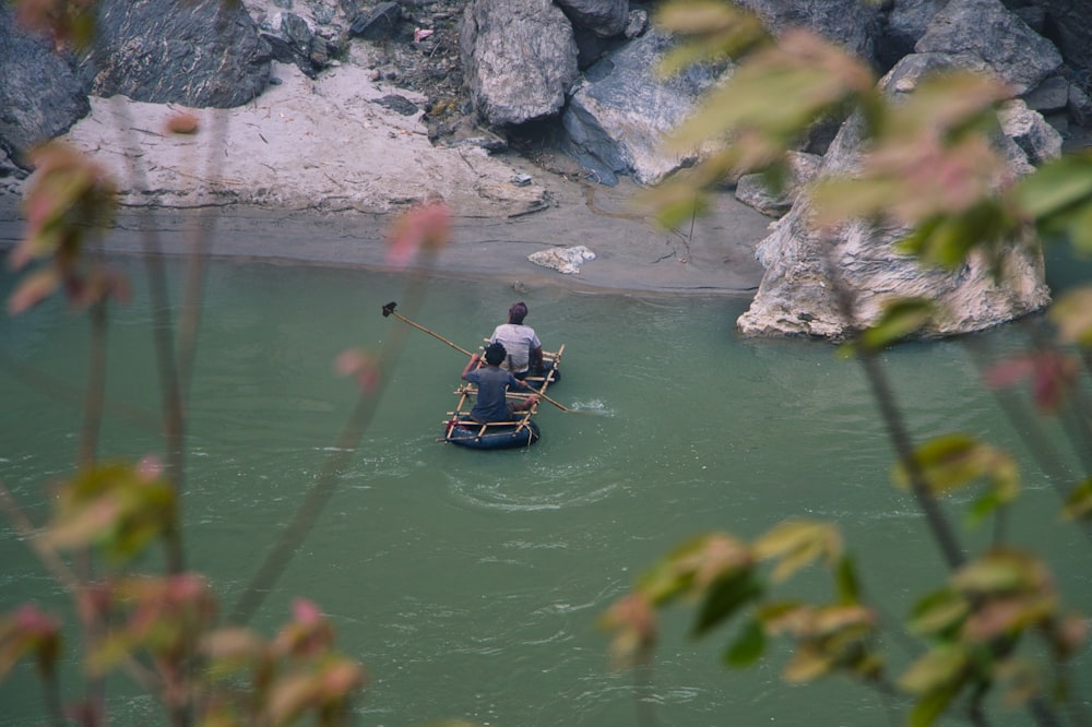 a couple people in a canoe on a river
