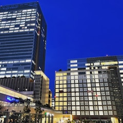 Evening shot of a completed commercial development glowing with interior lights.