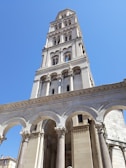 a tall white building with columns