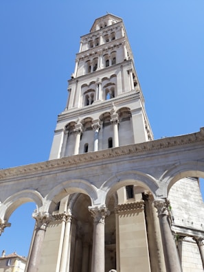 a tall white building with columns
