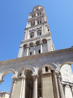 a tall white building with columns