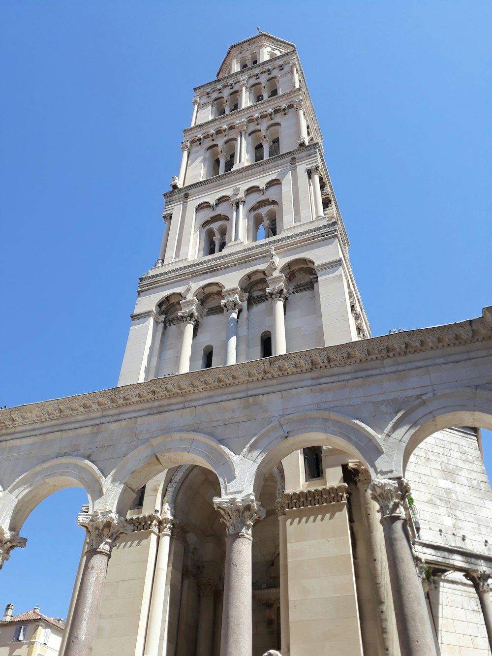 a tall white building with columns