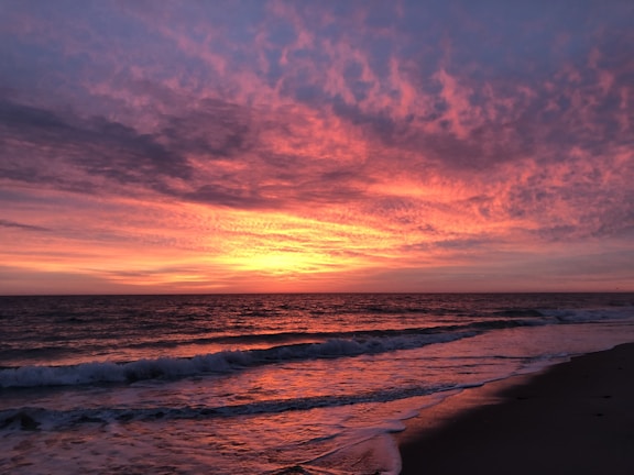 A vibrant sunset over a tranquil beach.