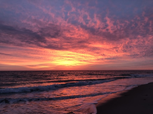 A vibrant sunset over a tranquil beach.