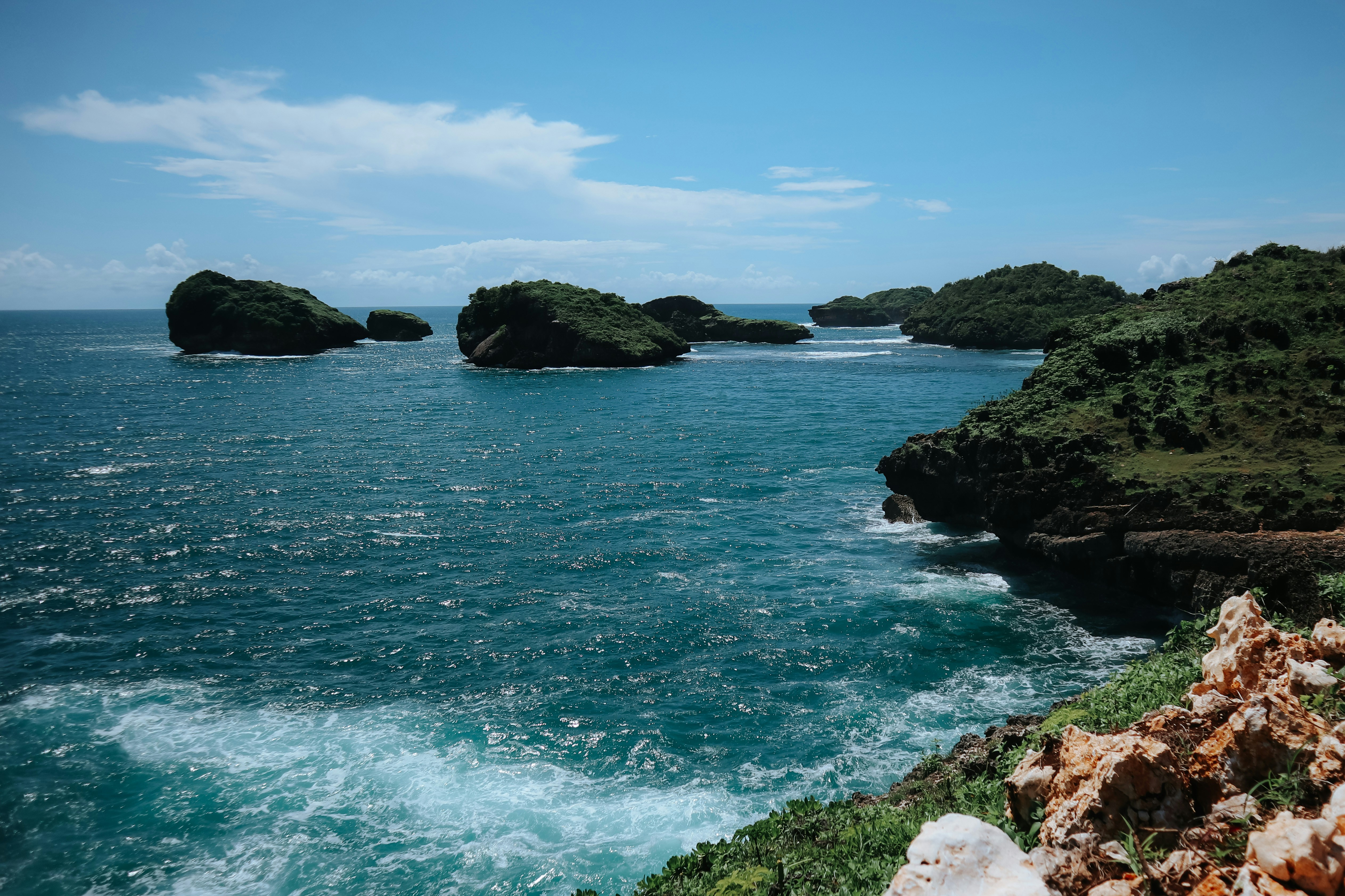 a body of water with rocks and trees around it