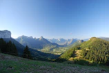 A panoramic view of mountains and valleys seen from a hot air balloon in flight