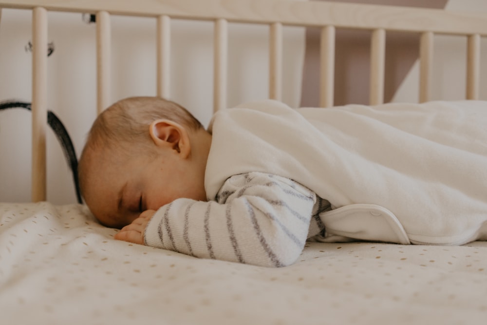 a baby sleeping in a crib