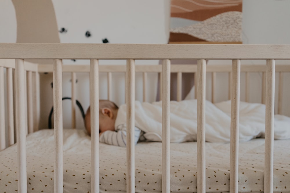 a person sleeping in a crib