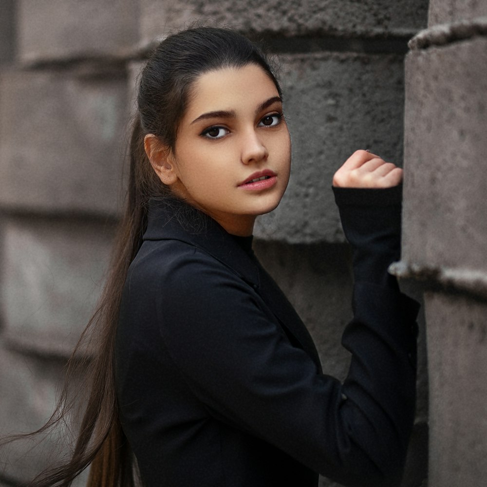 a person leaning against a wall