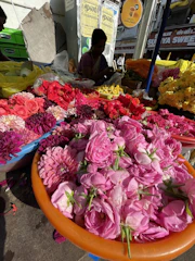 Vibrant bouquet of tropical Latin American flowers in a rustic market setting.