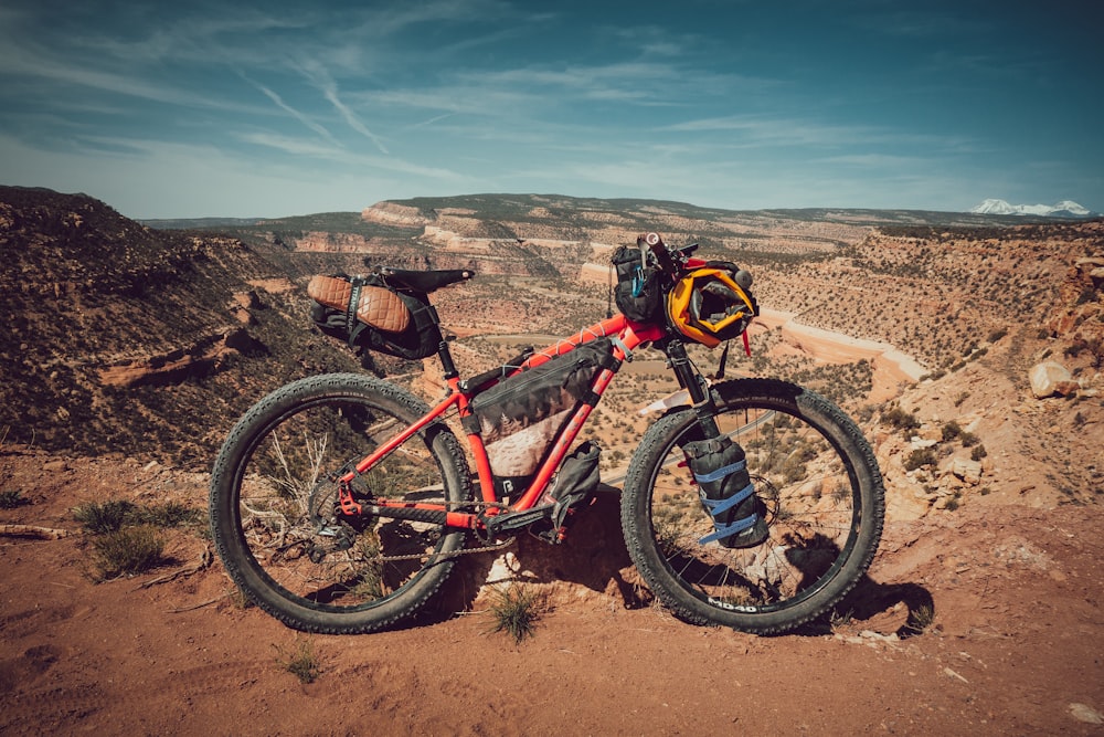 a red dirt bike parked on a dirt hill