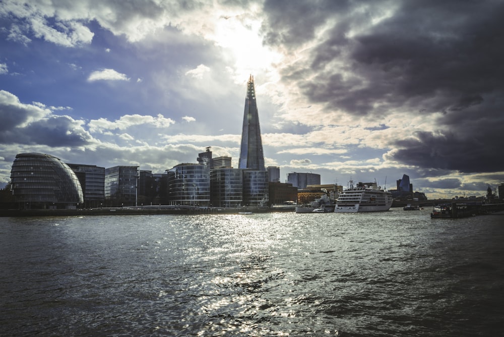 a city skyline with a body of water in front of it