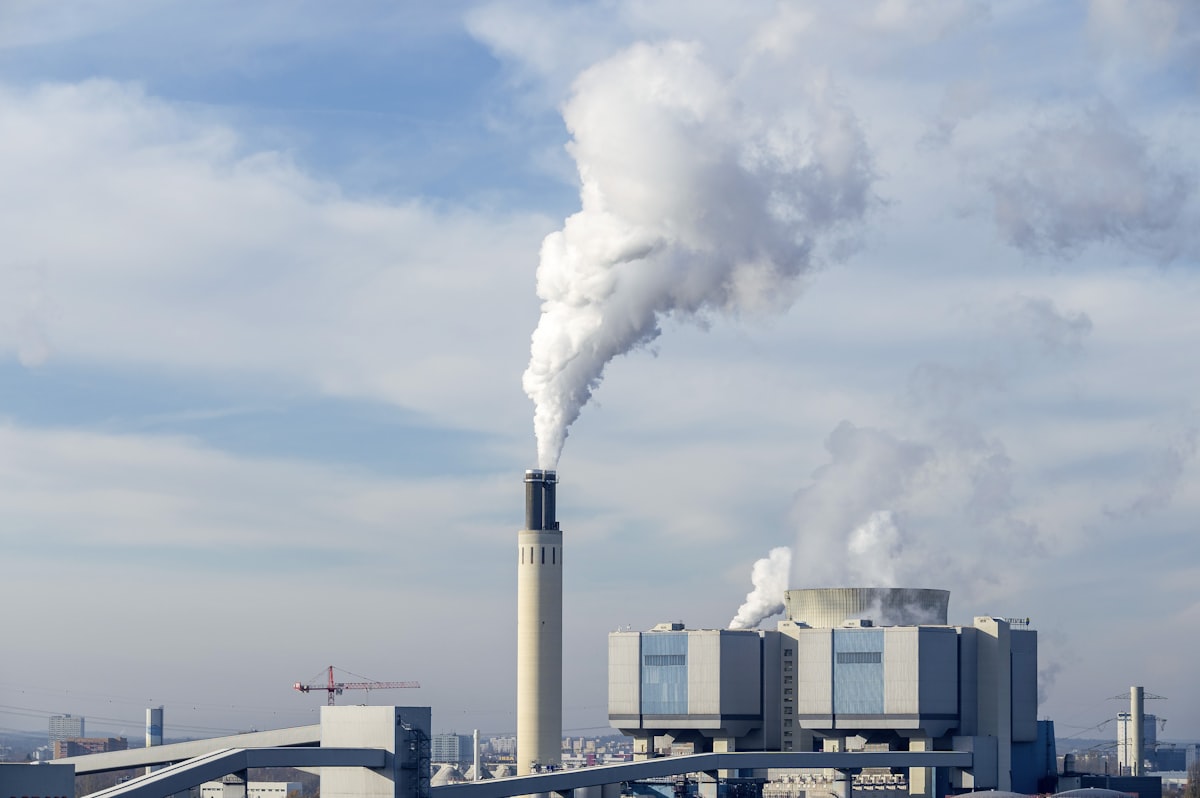 Natural gas power plant with cooling towers under blue sky