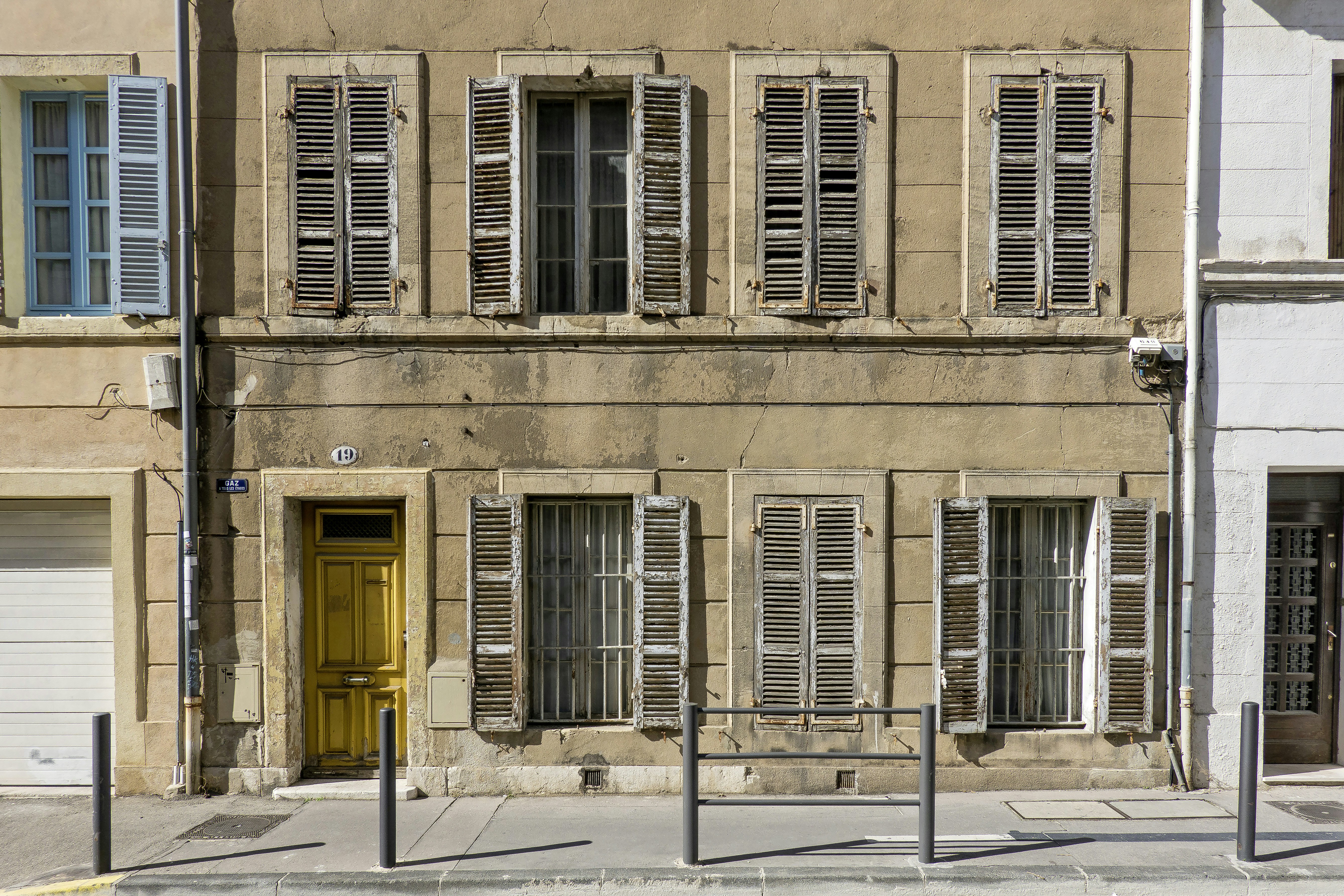 a building with shutters and windows