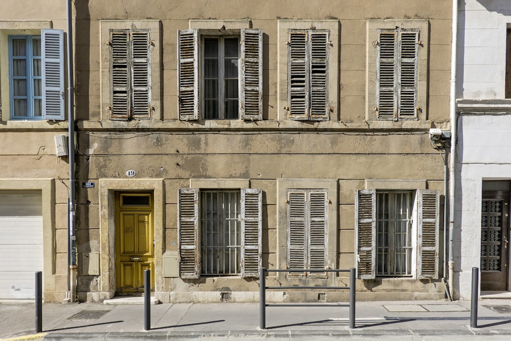 a building with shutters and windows