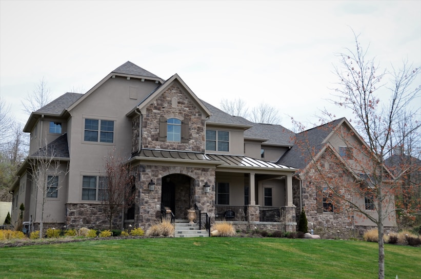 A freshly built modern family home with a welcoming front porch and landscaped garden.