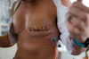 a close-up of a woman's chest with a tattoo on it