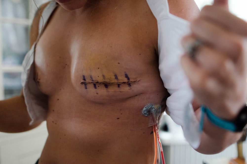 a close-up of a woman's chest with a tattoo on it