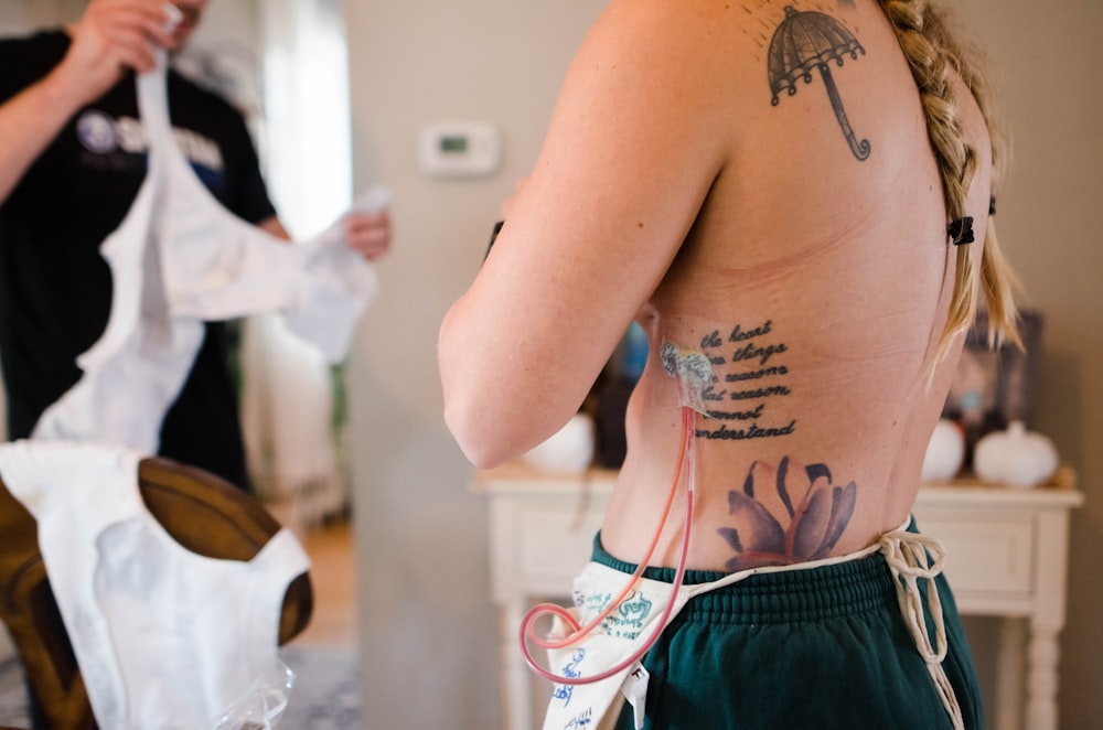 a woman with a tattoo on her back