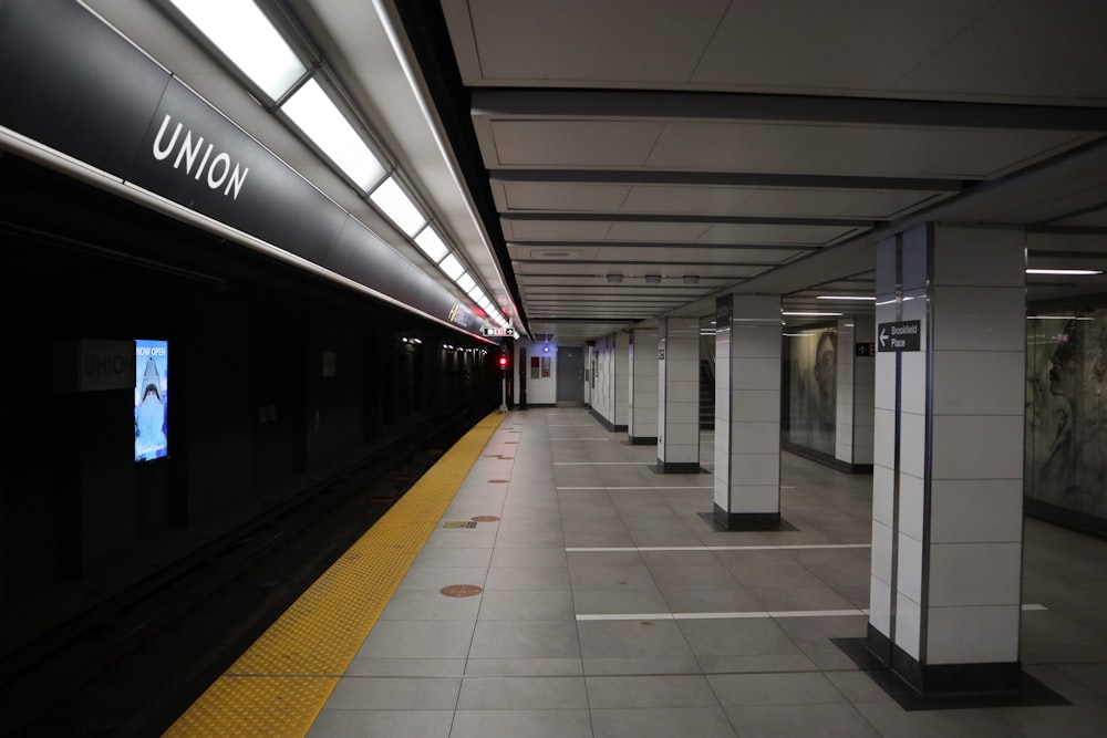 a train station with a yellow line