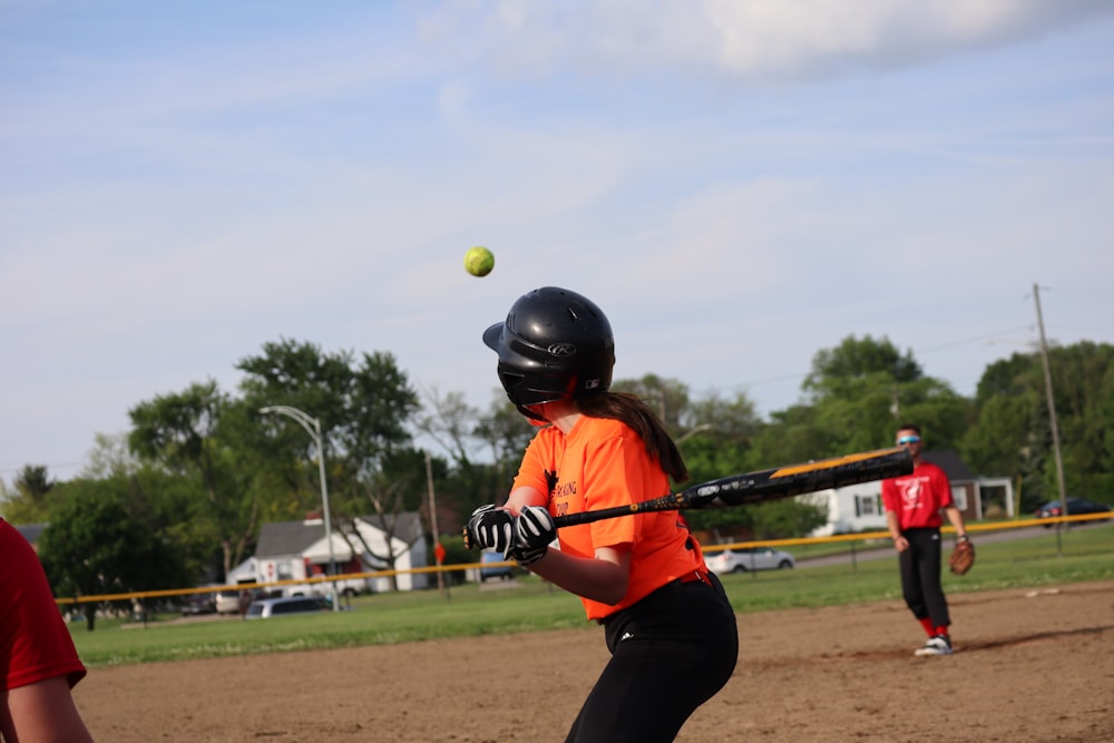 a girl swinging a baseball bat