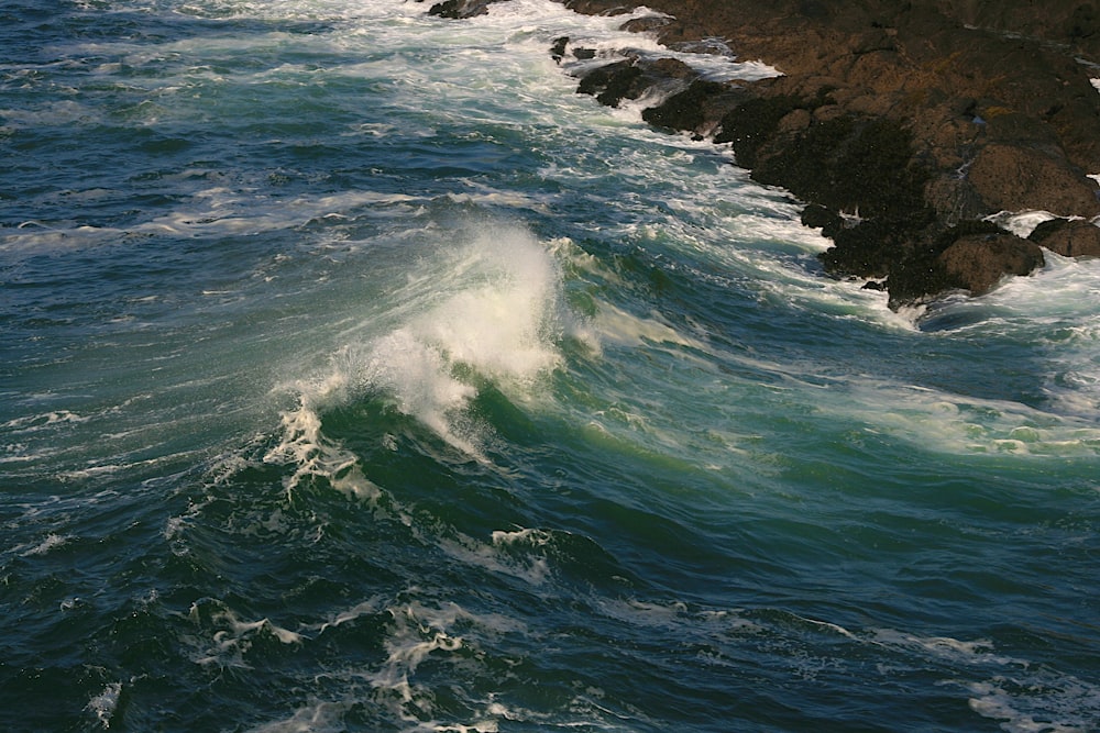 a wave crashing into rocks